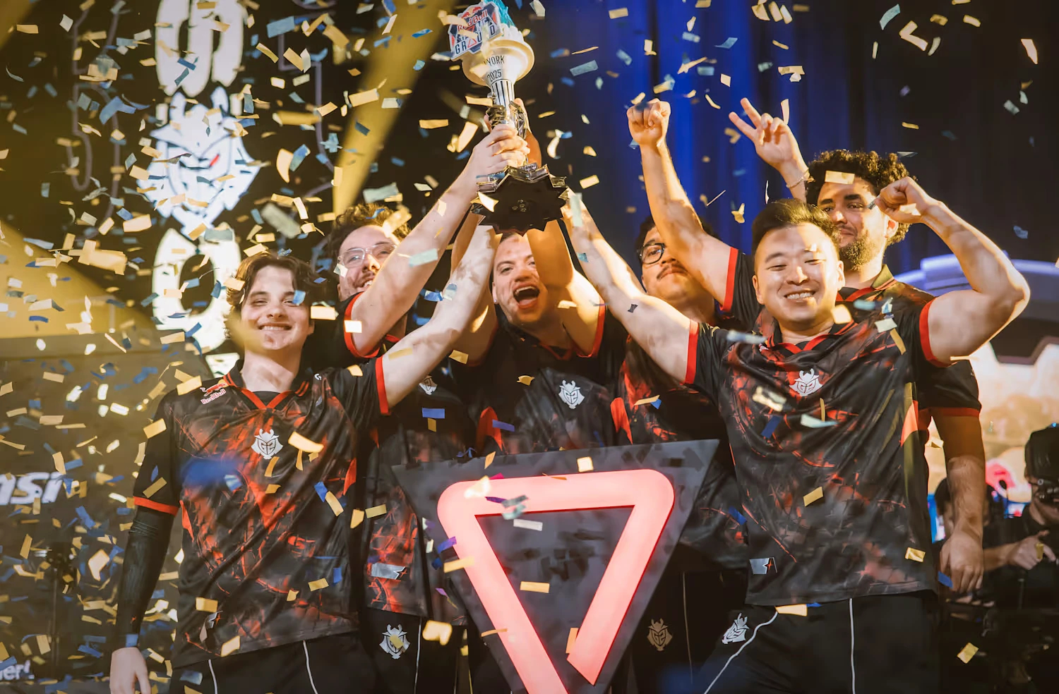G2 Esports lifting the Red Bull Home Ground 2025 torch trophy by Hoku Props on stage in New York under falling confetti