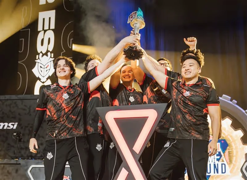 G2 Esports raising the Red Bull Home Ground 2025 trophy by Hoku Props on stage, the flame lit
