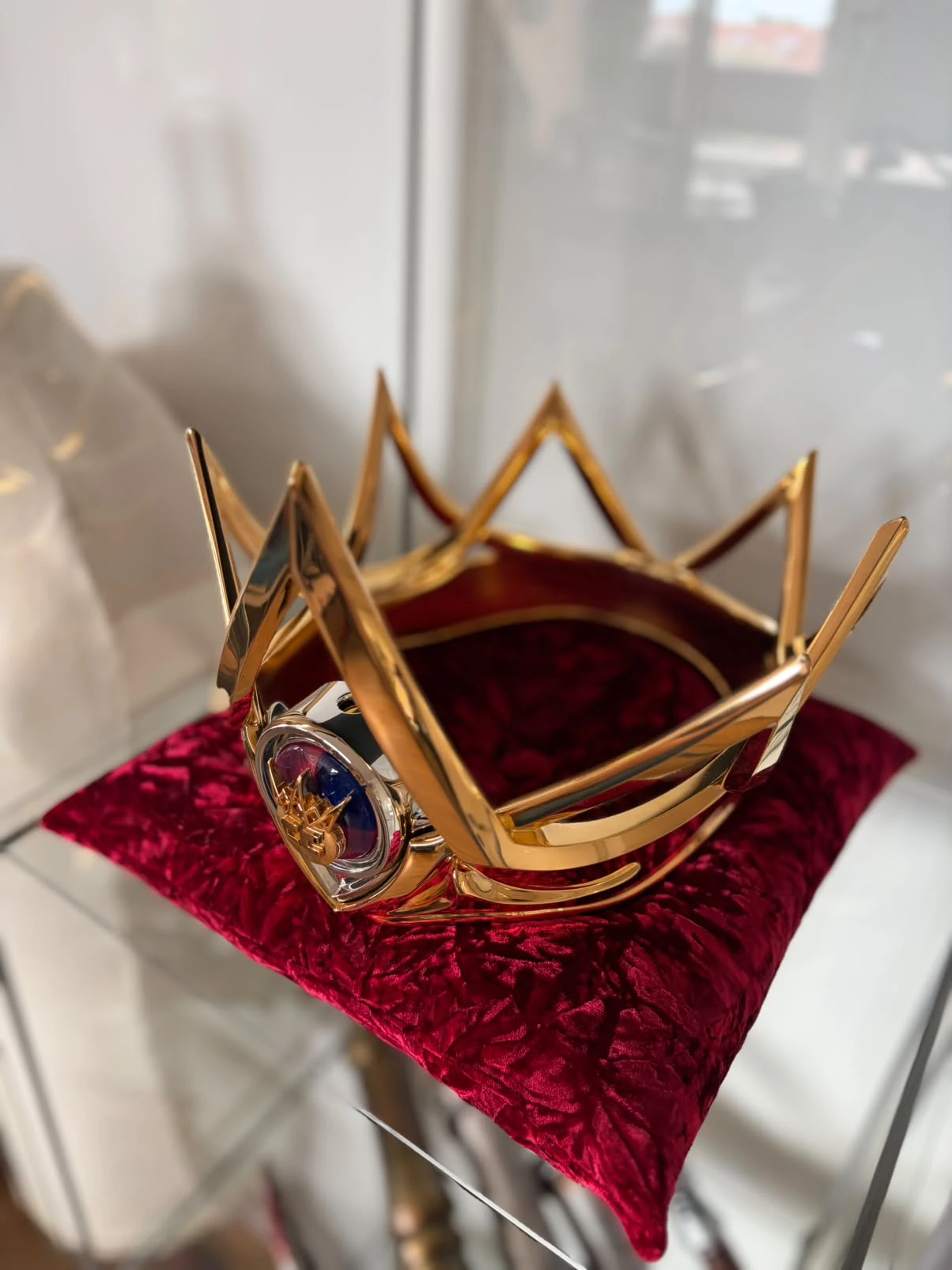 The mirror gold Crown Championships crown by Hoku Props seen from above, showing the pointed band and velvet-lined interior