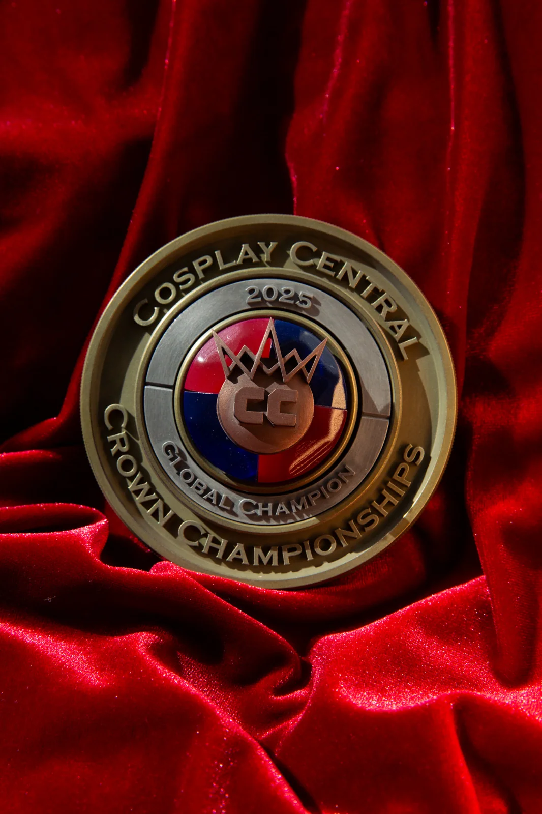 The 2025 Crown Championships Global Champion medal by Hoku Props in red and blue enamel with a gold crown