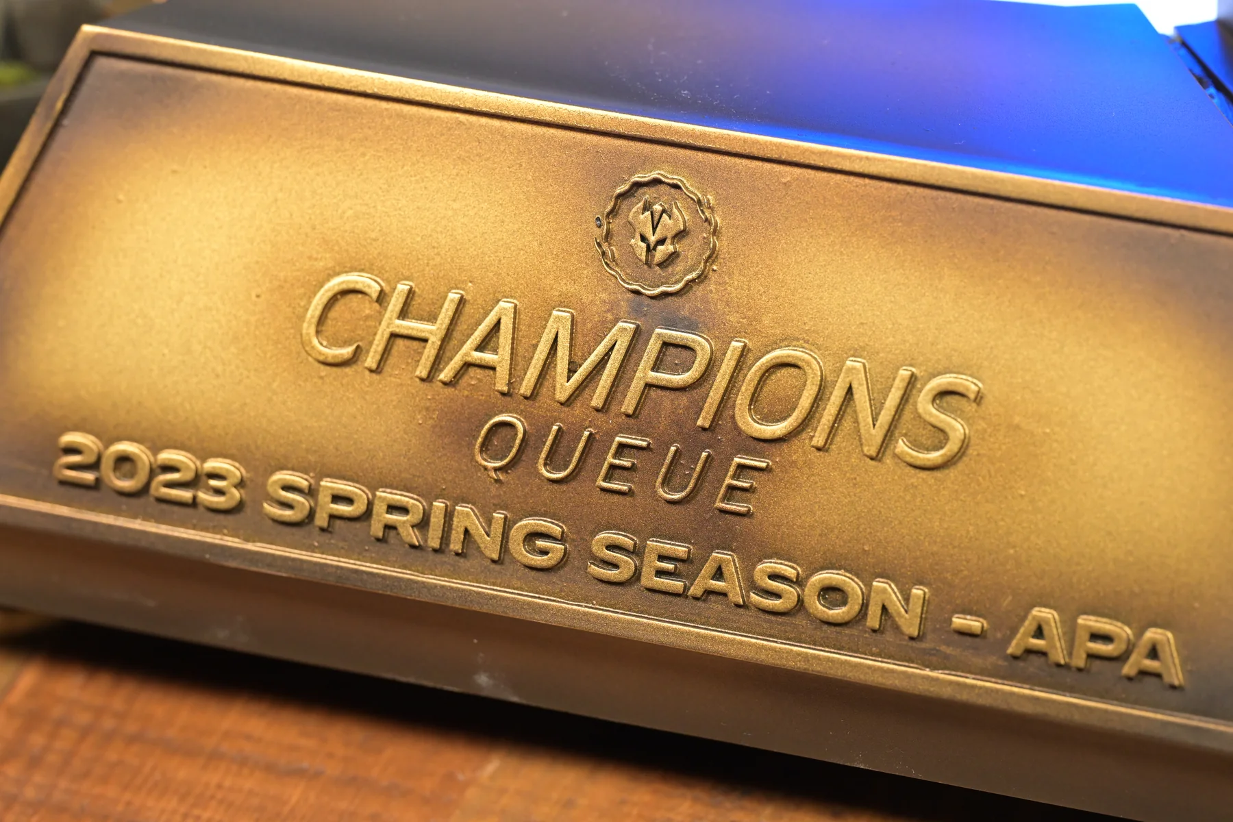 The Champions Queue 2023 Spring Season trophy built by Hoku Props: a gold and purple helmet floating above an illuminated hextech column on a stone base