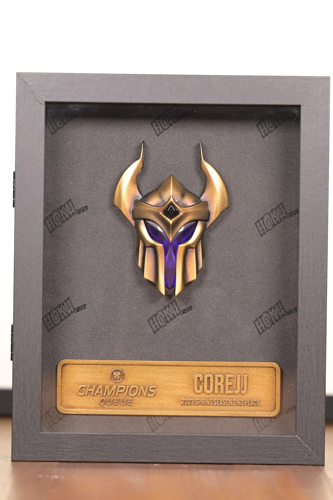 A framed Champions Queue award by Hoku Props with a sculpted helmet and engraved player plaque