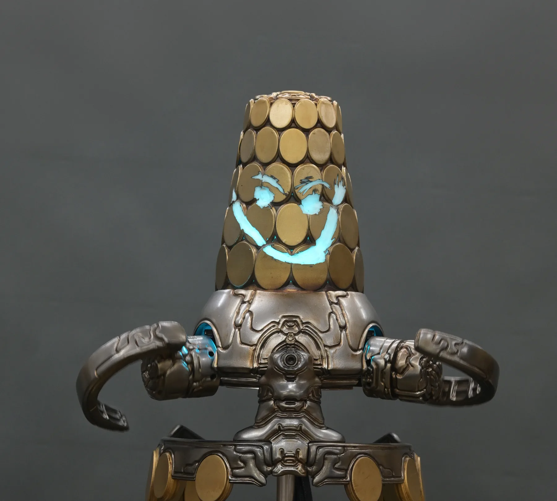 Loid with its face glyphs lit blue and Otak arms spread, mounted on top of the Secrets of the Sanctum cabinet