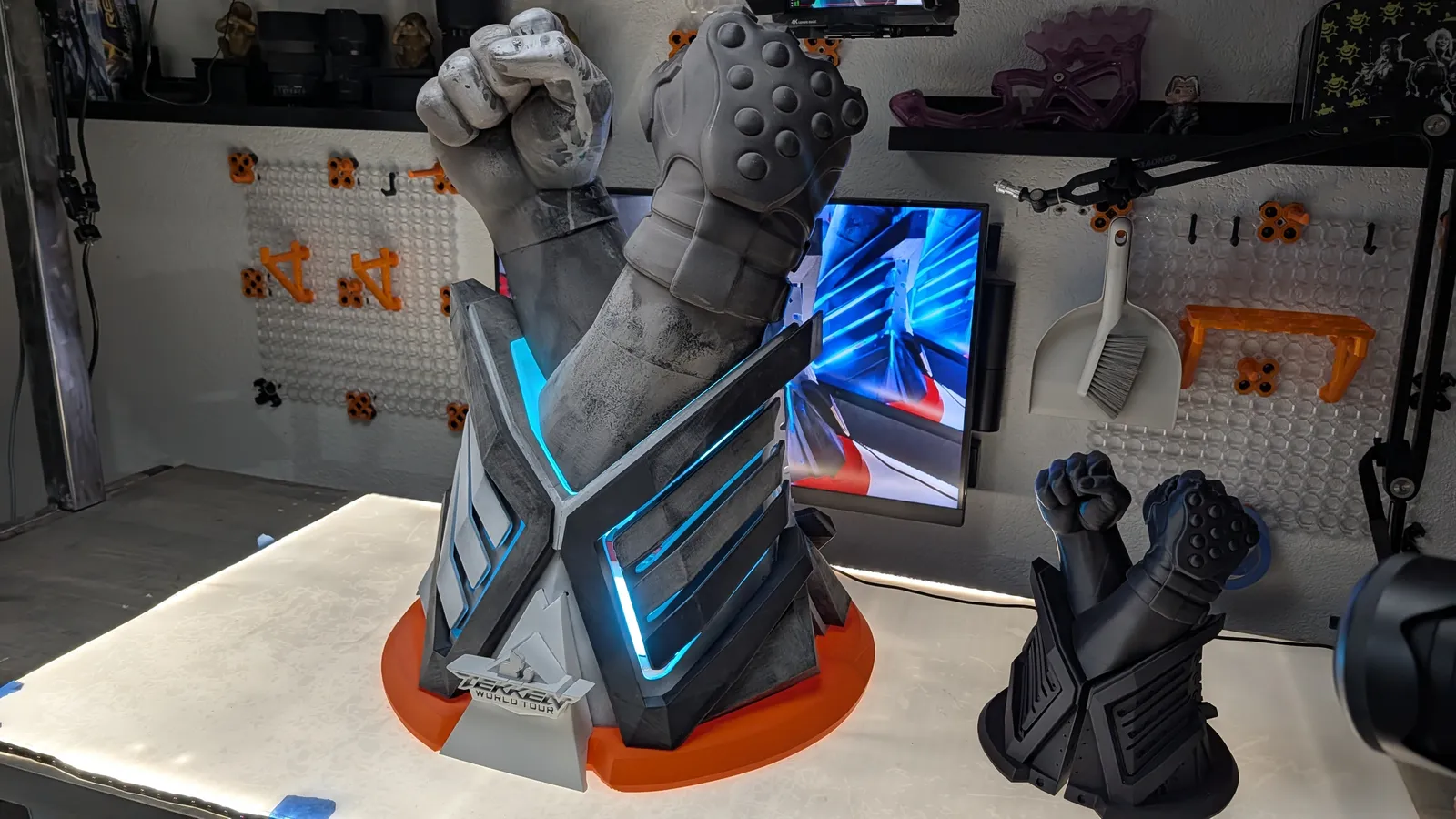 The TEKKEN World Tour 2025 trophy lit on a turntable in the Hoku Props shop