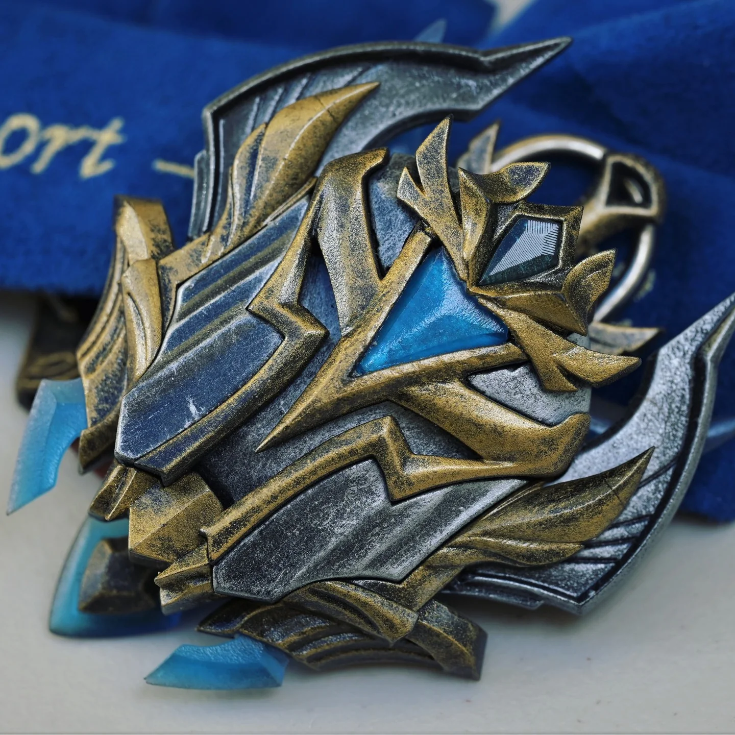 A blue, silver, and gold Challenger medal and presentation case made by Hoku Props