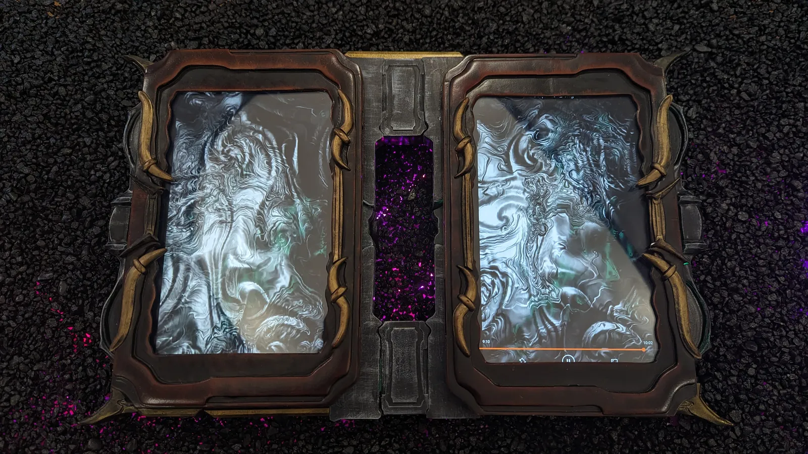 Albrecht's Grimoire by Hoku Props opened flat, two framed screen pages with swirling imagery