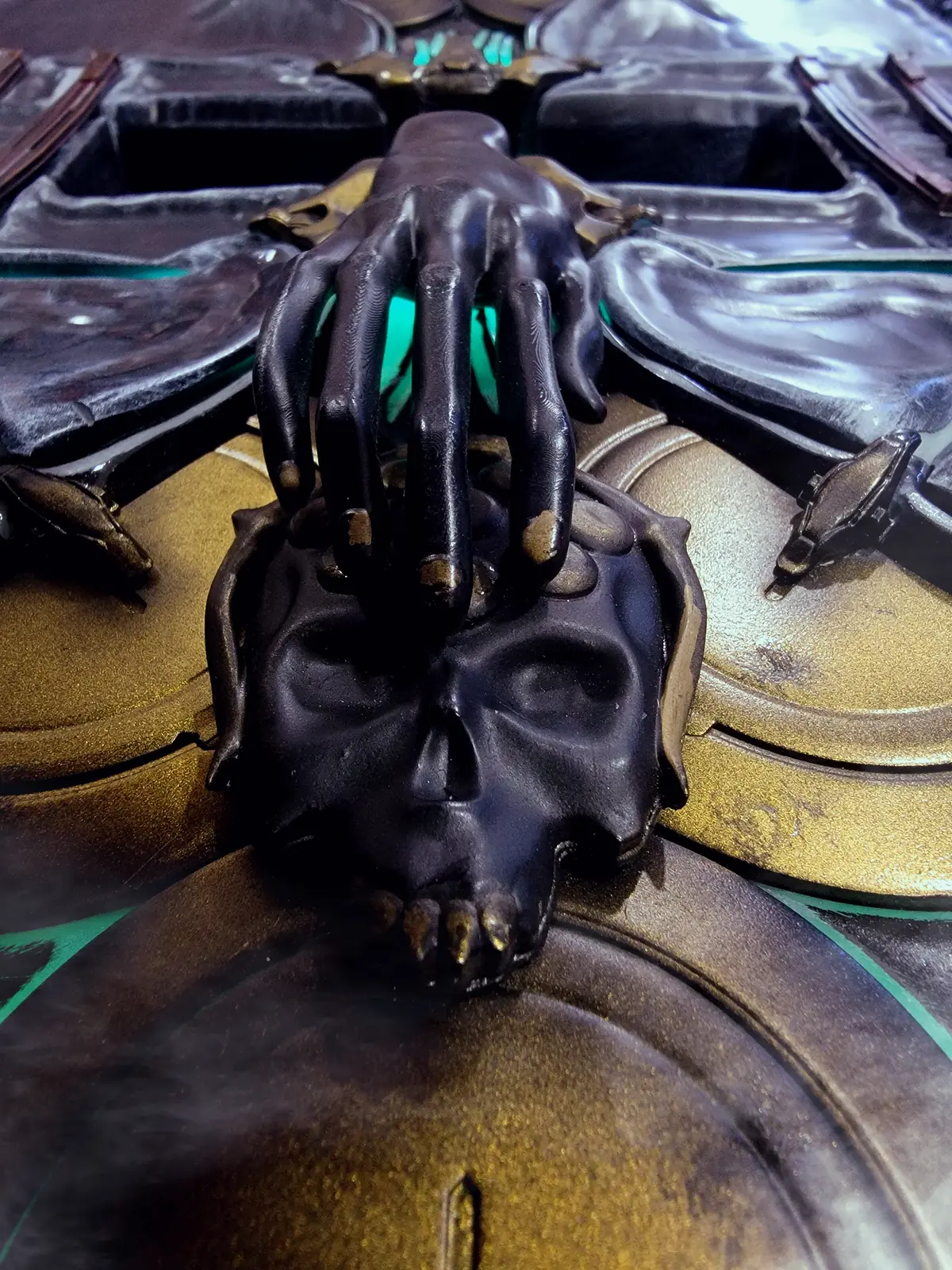 Close view of the sculpted black skull and hands at the centre of the Hoku Props Albrecht's Grimoire