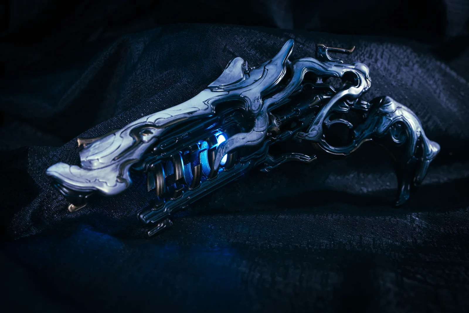 Full side profile of the Hoku Props Sirocco pistol showing the chrome body, grip and lit core