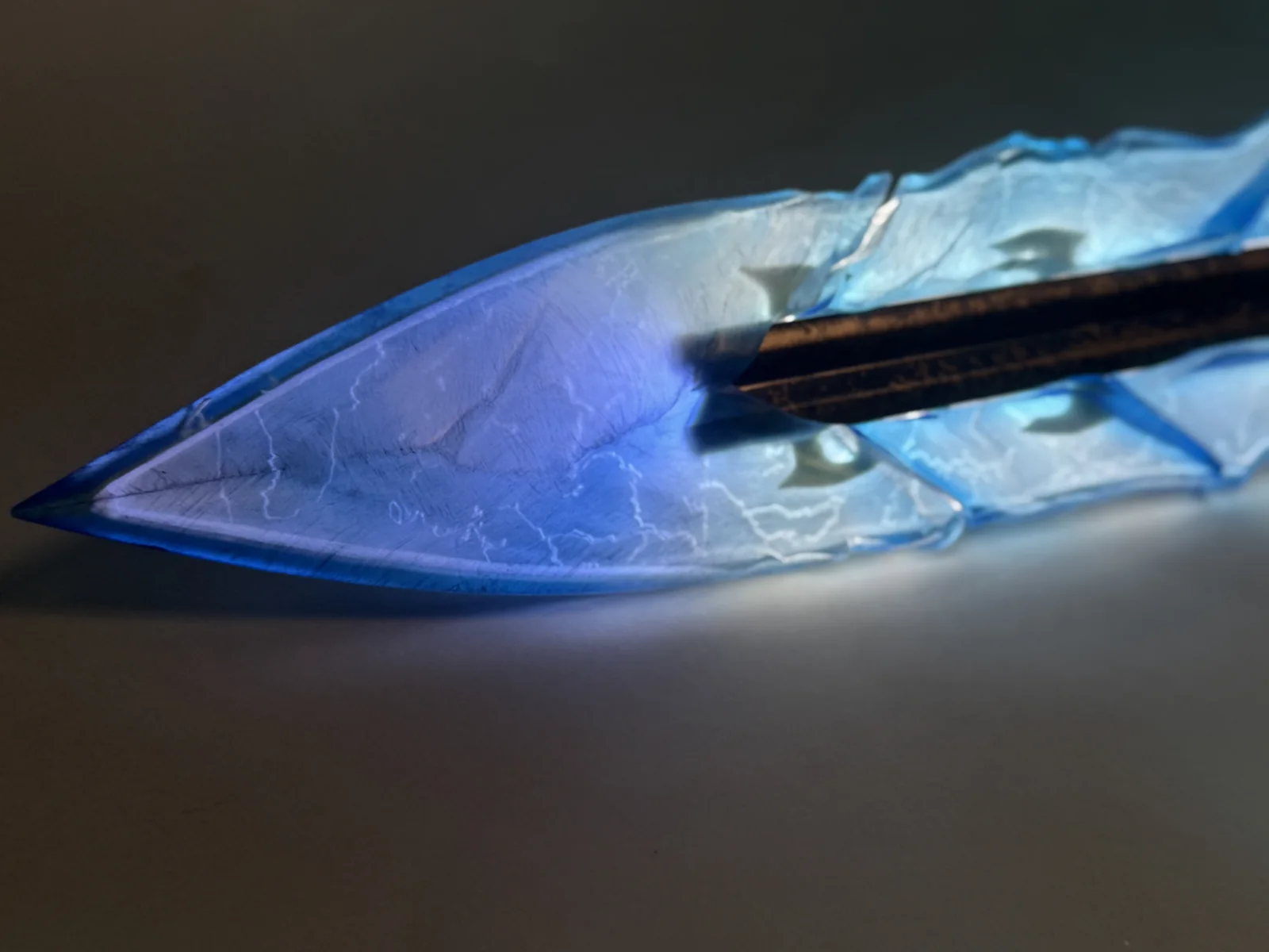 Close-up of the illuminated translucent blue blade on the Highguard Shieldbreaker sword replica by Hoku Props
