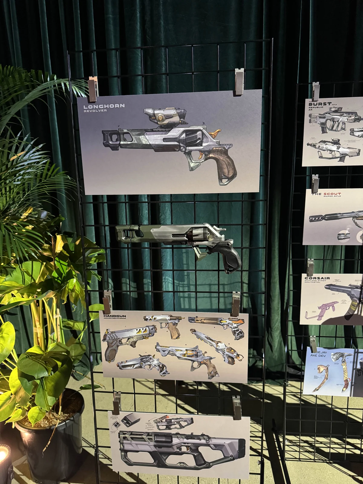 The Hoku Props Longhorn revolver replica displayed beneath its Highguard concept art at a Wildlight Entertainment event