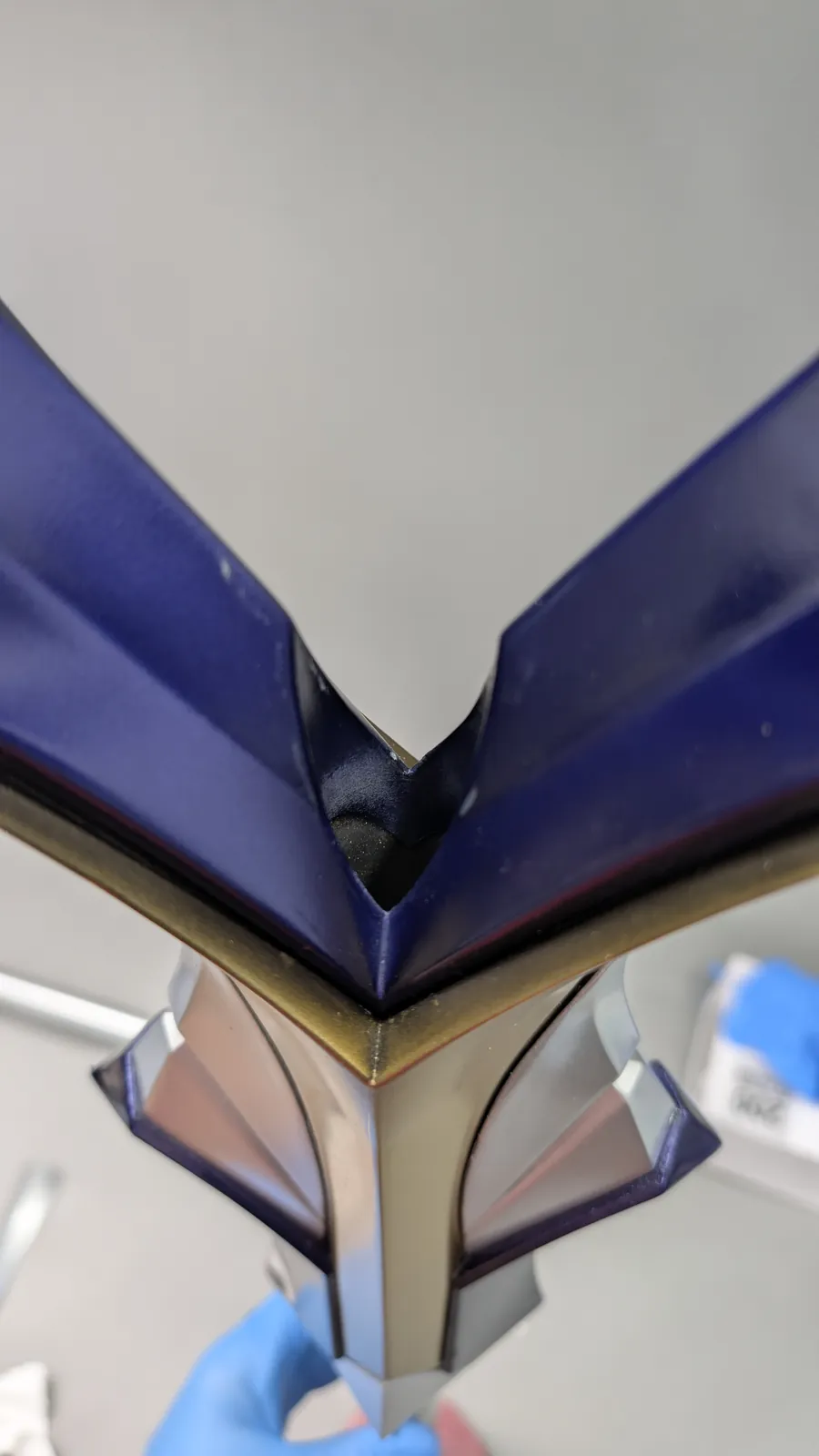 Close view of an assembled joint where the navy and silver sections of the spear head meet