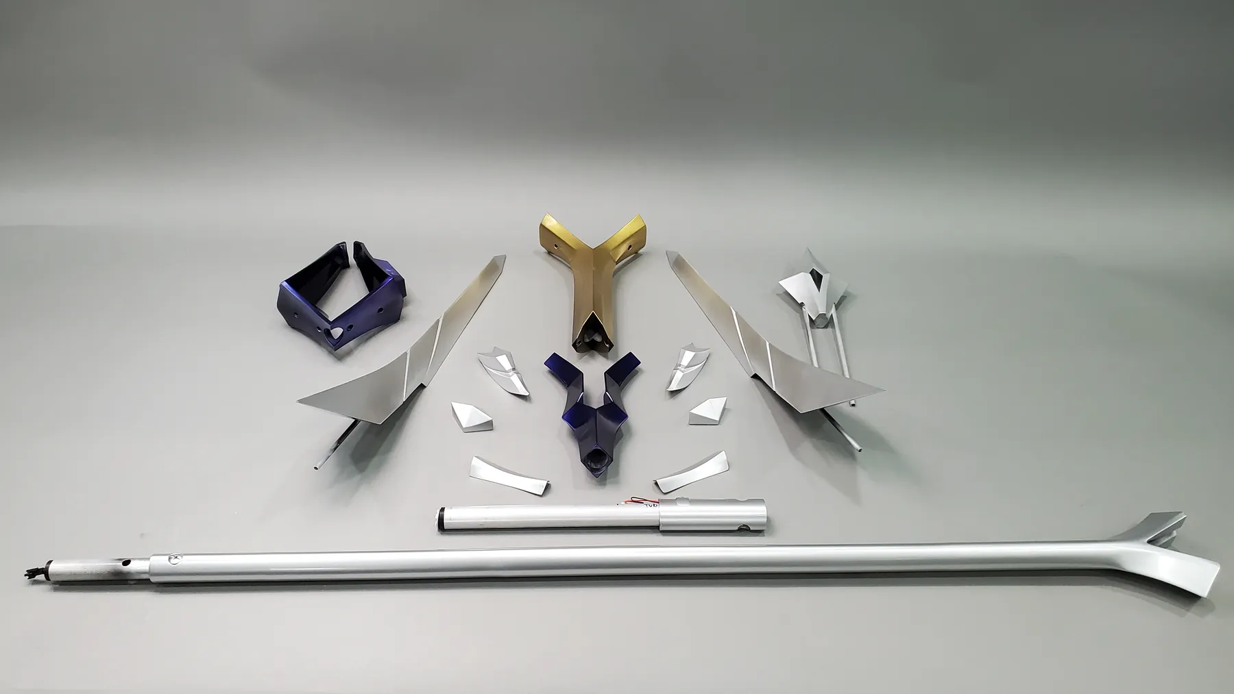 Printed and painted sections of the Xin Zhao spear laid out on a grey backdrop before assembly